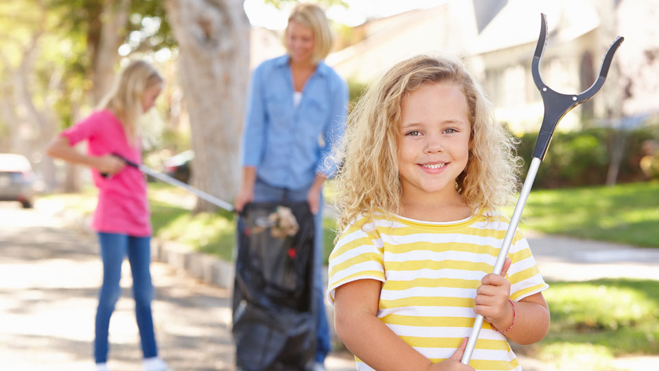 Mother and Daughters Picking up Trash