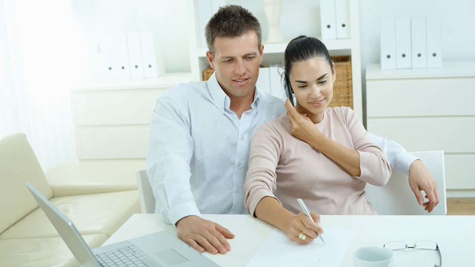 Happy Couple paying bills