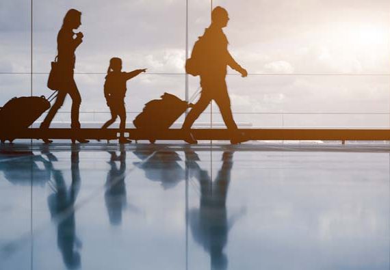 Family with luggage walking at airport