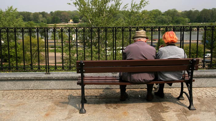 Two people sitting on a bench