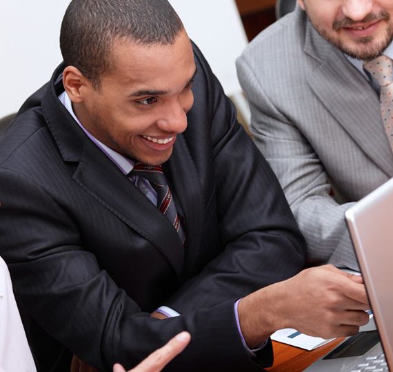 Business team looks at a computer