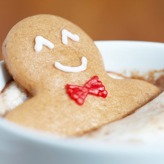 Gingerbread cookie man in a hot cup of cappuccino