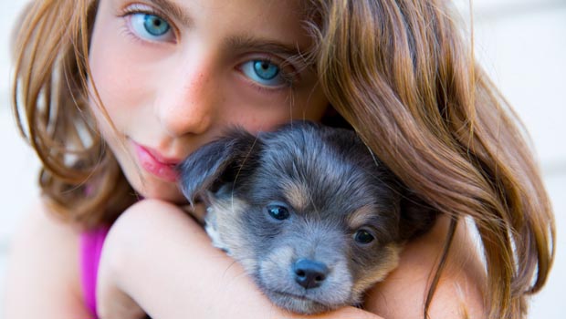 Girl hugging her puppy