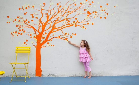 Girl reaching for tree