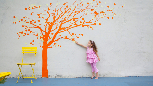 Girl reaching for tree