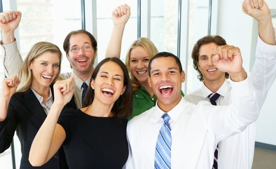 Happy workers cheering in an office