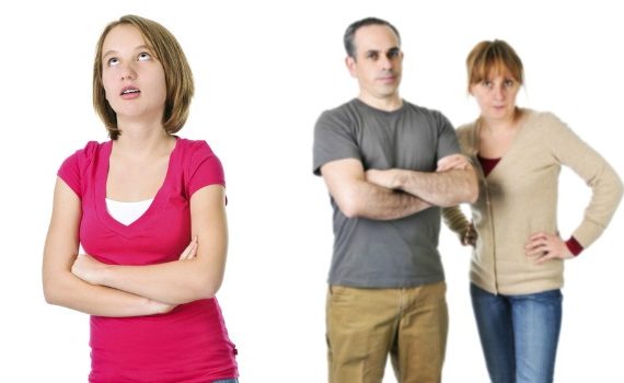 Teenager rolling her eyes, parents in background