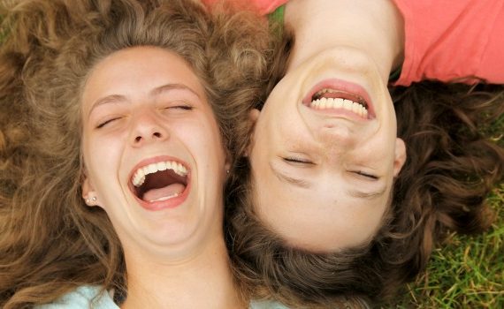 Women on grass laughing