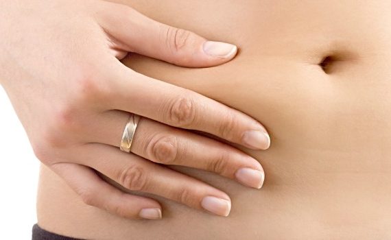 Woman squeezing her stomach