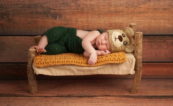 Baby sleeping on a tiny bed