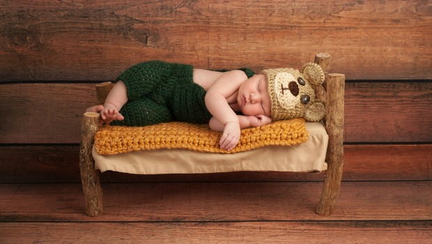 Baby sleeping on a tiny bed