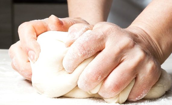 Hands kneading dough