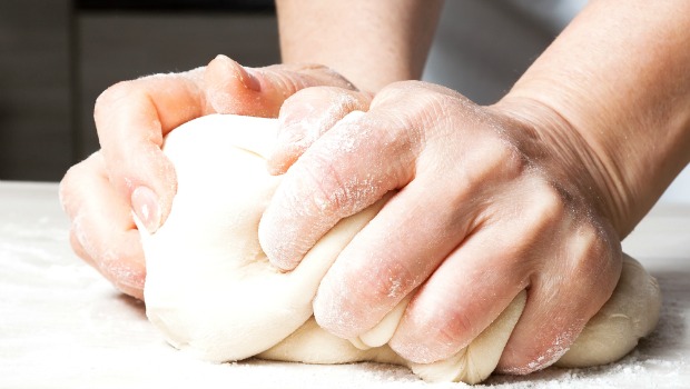 Hands kneading dough