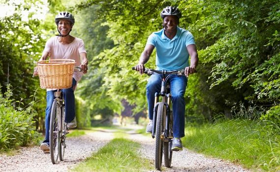 Happy people riding bikes on a path