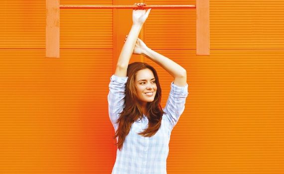 Woman standing in front of orange wall