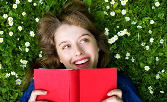 Woman on grass reading a book