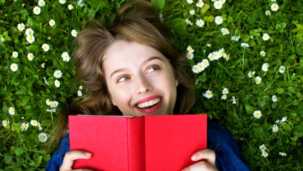 Woman on grass reading a book