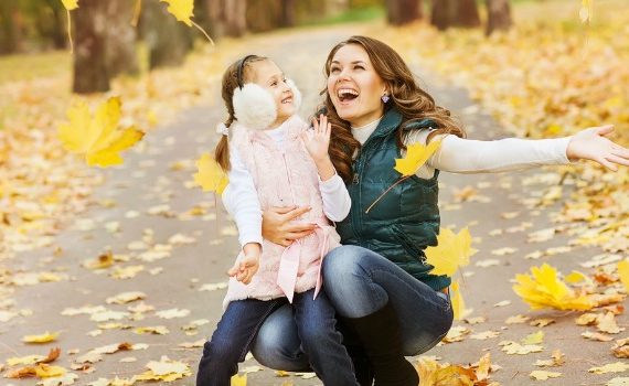 Mom and child in falling leaves