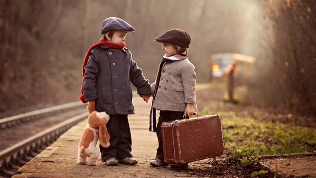 Kids standing at a train station