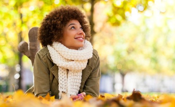 Woman in fallen leaves