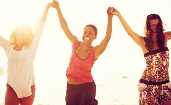 Three happy woman at the beach