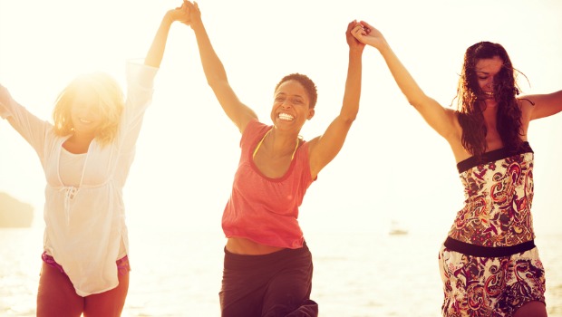 Three happy woman at the beach