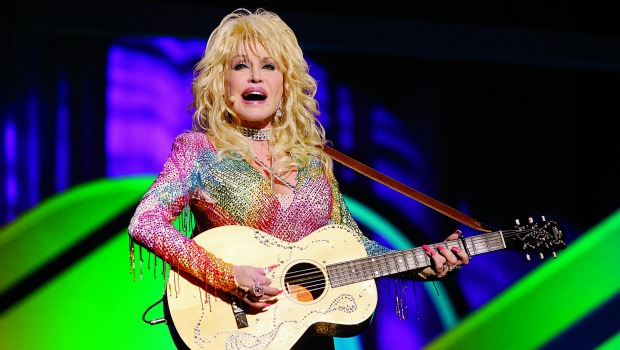 Dolly Parton playing guitar onstage