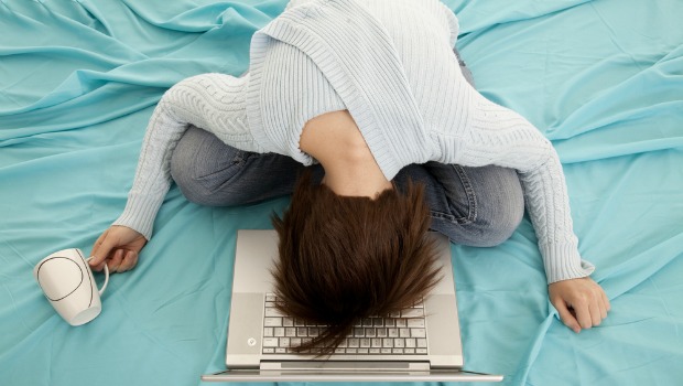 Woman collapsing on her bed.