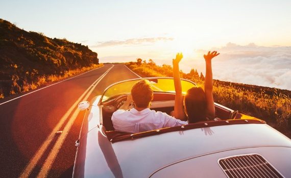 Cute couple in a convertible car.