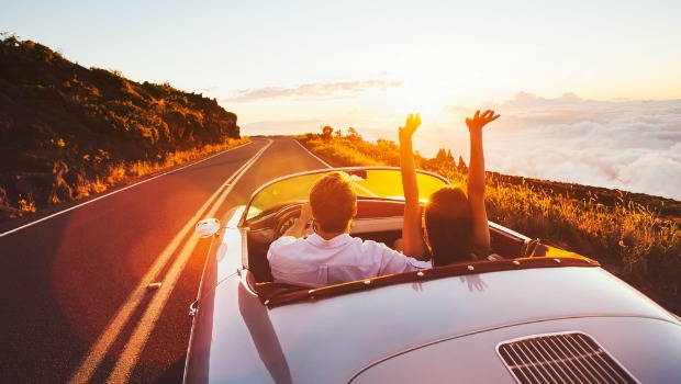 Cute couple in a convertible car.