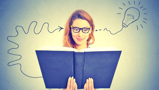 Woman with open book, her head filling with amazing ideas.