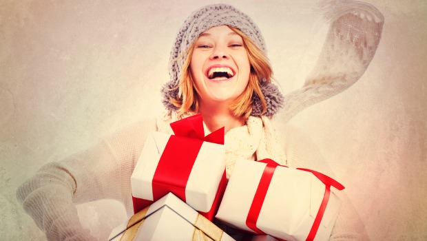 Smiling woman with holiday presents.