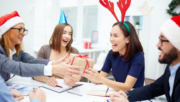 Colleagues exchanging presents at a meeting.