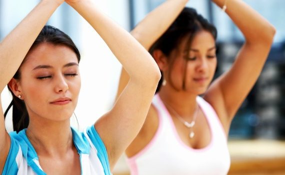 Two women doing yoga and meditation