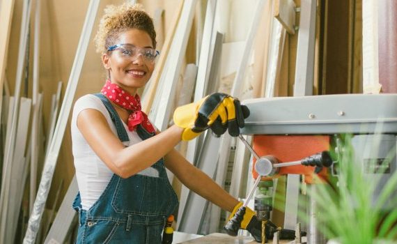 Confident woman working with a table saw.