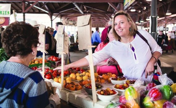 Woman buying tomatoes at Eastern Market.