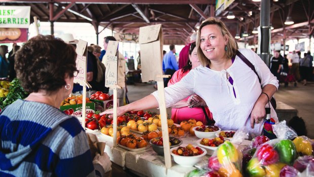 Woman buying tomatoes at Eastern Market.