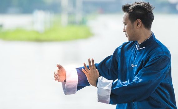 Man practicing qi gong outdoors.
