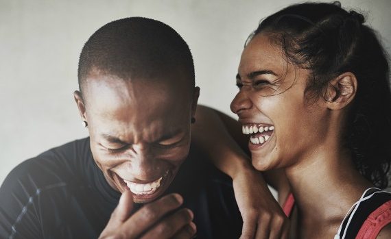 Cute couple laughing hard together.