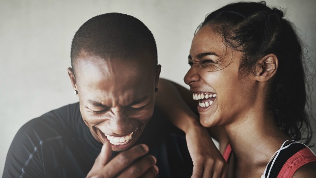 Cute couple laughing hard together.