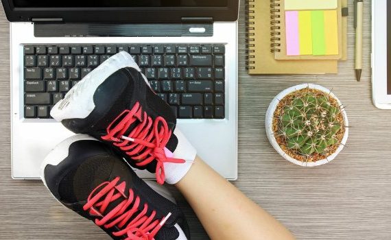 Worker with feet up on her desk.