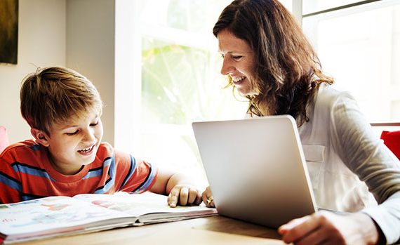 Mom helping her son do homework.