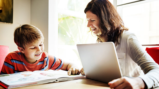 Mom helping her son do homework.