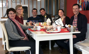 People sitting down to dinner