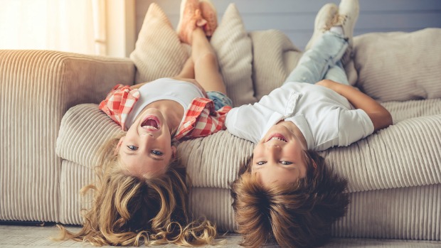 Happy kids playing on the couch.