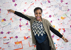 Smiling woman at a Happiness Wall