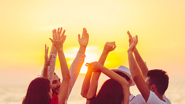 People celebrating happiness on a beach.