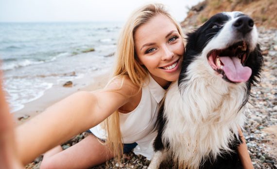 Woman taking selfie with her dog