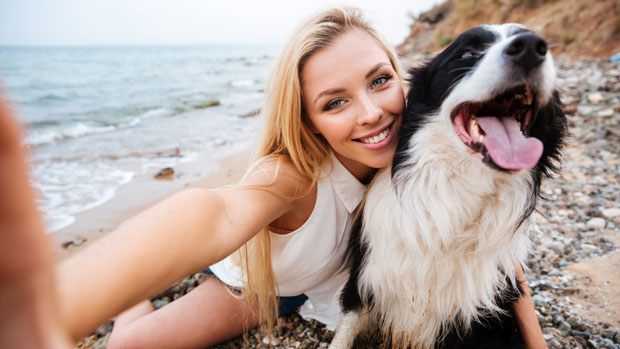 Woman taking selfie with her dog