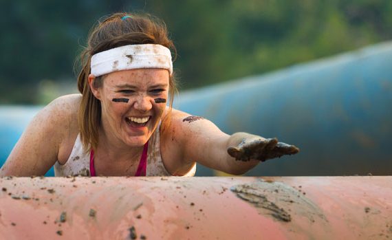 Woman participating in a mud run.